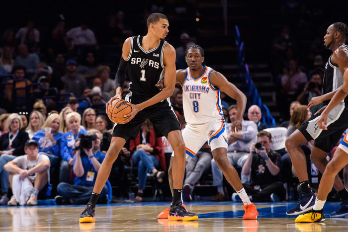 San Antonio Spurs center Victor Wembanyama (1) with the ball while defended by Oklahoma City Thunder forward Jalen Williams (8) during the first half at Paycom Center.